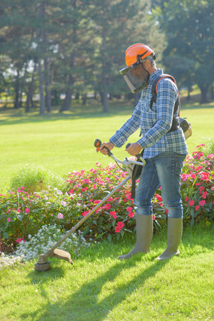 Man strimming grass