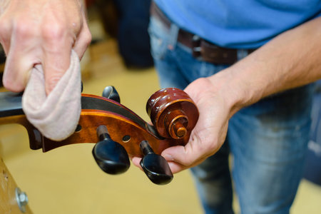 Man polishing musical instrumentの写真素材