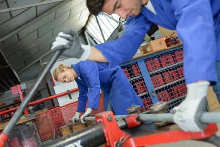 Man and woman levering machineryの写真素材