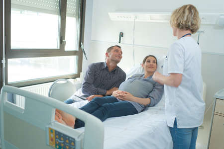 Expectant couple in hospital roomの写真素材