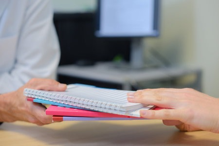 handing over notebooksの写真素材