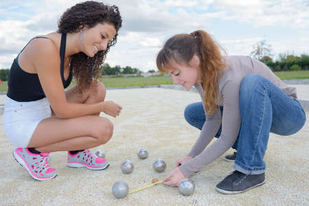 Women measuring distance between bowlsの写真素材