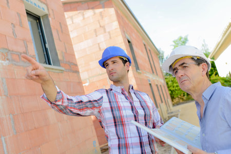 Two architects working on site