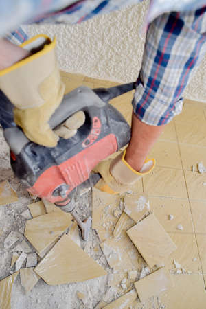 Using pneumatic device to break old tilesの写真素材