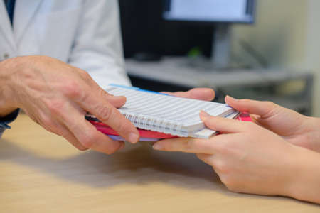 handing a notebookの写真素材