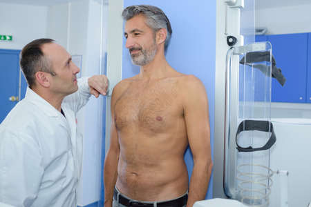 shirtless patient having chest scan in hospitalの写真素材