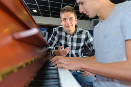 Teenager playing pianoの写真素材
