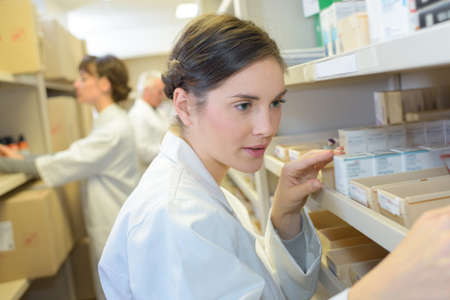 pharmacist finding medicine in storeroomの写真素材