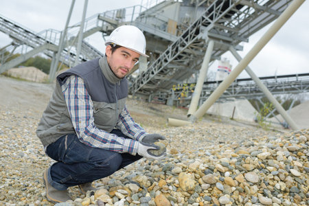 worker holding a rockの写真素材