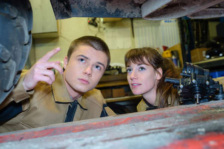 worker looking at a broken vehicleの写真素材
