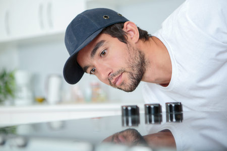 Fitter checking installation of hobの写真素材