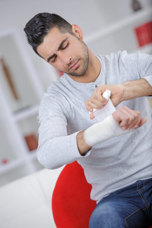 boy keeps broken arm in gypsum plaster armの写真素材
