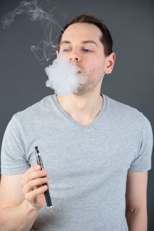 man smoking a controversial vaping an electronic cigarette