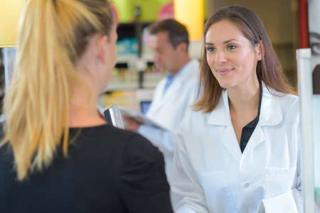 pharmacist helping a customerの写真素材