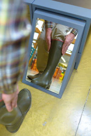 fitting a pair of bootsの写真素材
