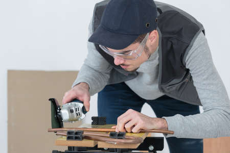 confident handsome young craftsman in workshopの写真素材