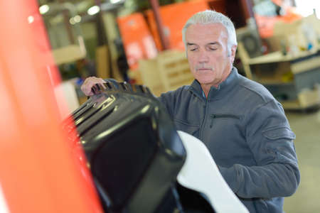 Worker putting object into containerの写真素材