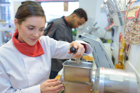 woman pork butcher serving sausages to customer