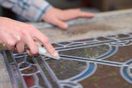 Lady working with stained glassの写真素材