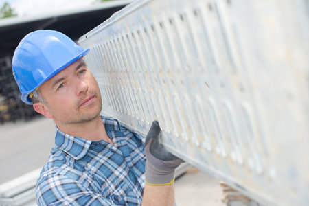 Man carrying scaffolding platform