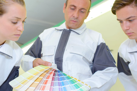 Decorators looking at color charts