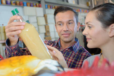 Couple looking at bottleの写真素材