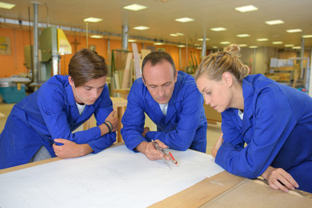 Workers around table looking at paperwork
