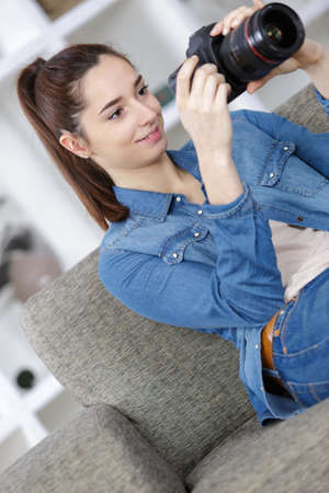 portrait of cute young teen with her photo cameraの写真素材