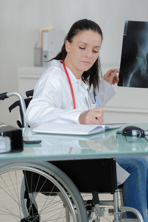brave disabled female doctor examining x ray