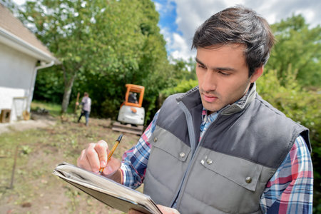 Foreman holding paper and pen
