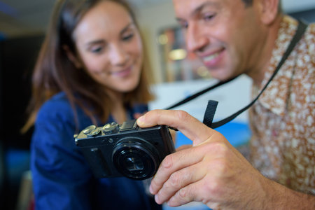 Couple looking at screen of digital camera