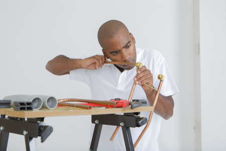 Man shaping copper pipeの写真素材