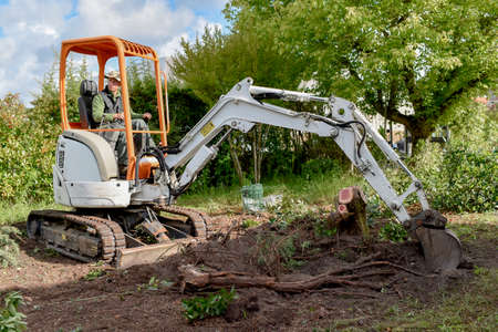Man using a digger in the gardenの写真素材