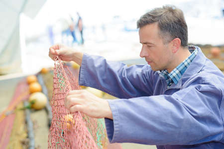 fisherman with netの写真素材