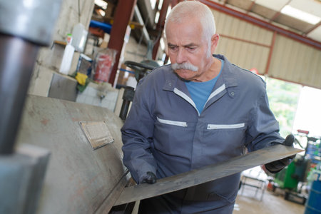 Man feeding metal into machine