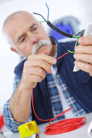 casual senior electrician at workの写真素材