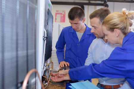 Workers assessing fridge