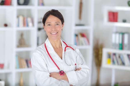 smiling beautiful woman in white medical uniform and stethoscopeの写真素材