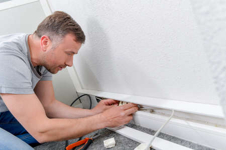Fixing a wall socketの写真素材