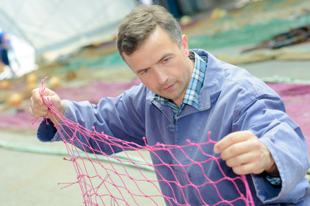 fisherman untangling net
