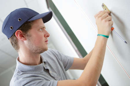 Tradesman fitting part to wallの写真素材