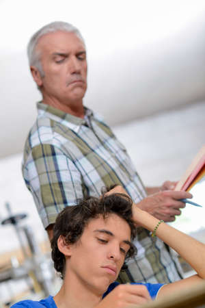 Man keeping an eye on a teenagerの写真素材