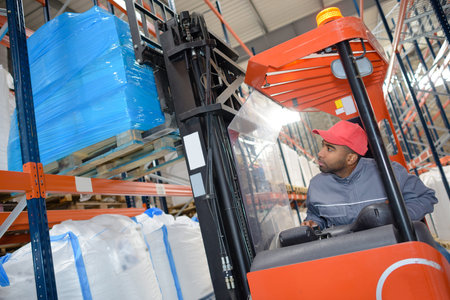 Warehouse worker driving forklift