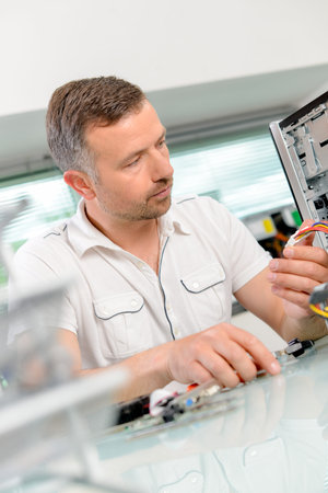 Man repairing his computer
