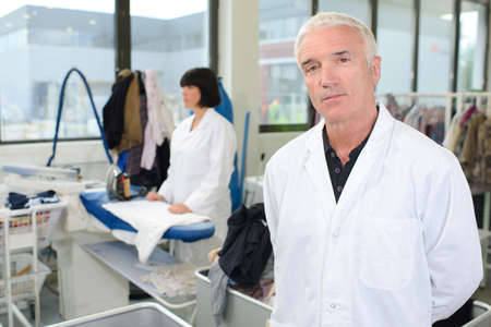 Portrait of man in professional laundretteの写真素材