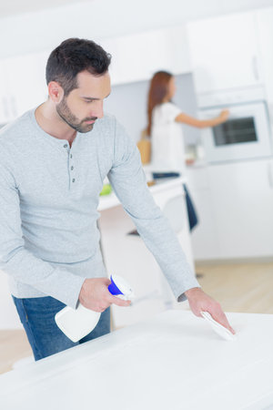Man spraying kitchen table