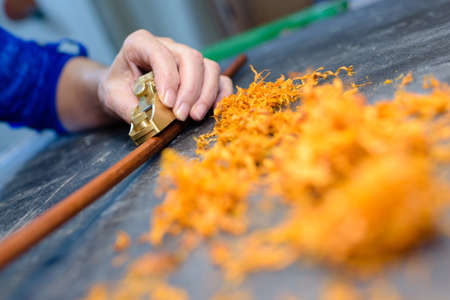 close up carpenters hands that work with cutterの写真素材