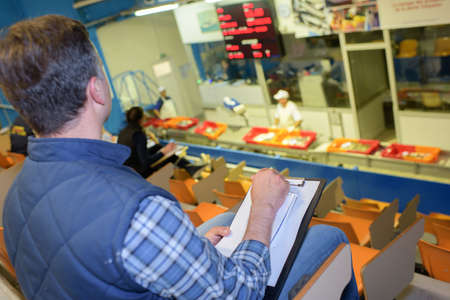 Rear view of man in auction hallの写真素材