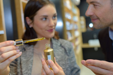 saleswoman and man shopping for girlfriend
