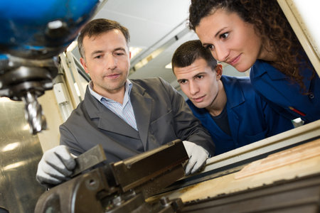 Students watching instructor using bench drill